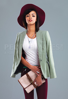Buy stock photo Studio portrait of a stylish young woman posing against a gray background