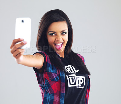 Buy stock photo Woman, selfie and smile with smartphone in studio for memory with hand for happy. Social media, communication and makeup with mobile for self esteem with positivity, confidence on grey background