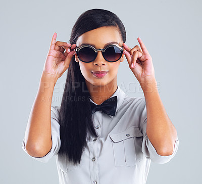 Buy stock photo Sunglasses, fashion and young woman in studio for gen z, designer brand and stylish clothes. Confident girl, eyewear and edgy outfit on backdrop for aesthetic, advertising and trendy accessories. 