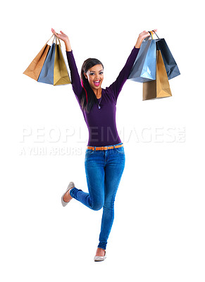 Buy stock photo Full length studio portrait of a young woman holding up shopping bags against a white background