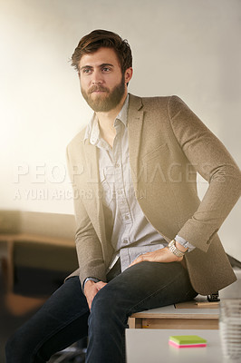 Buy stock photo Shot of a young businessman sitting in his office