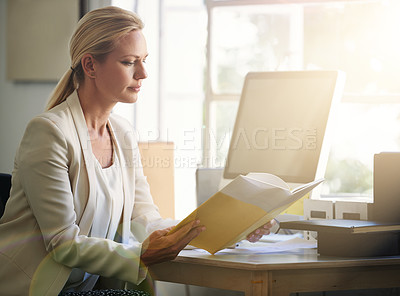 Buy stock photo Cropped shot of a businesswoman reading a book in her office