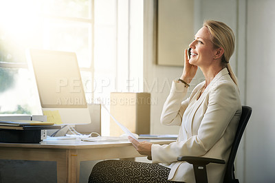 Buy stock photo Shot of a businesswoman talking on her cellphone while sitting in her office