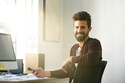Buy stock photo Portrait of a businessman using his cellphone in his office