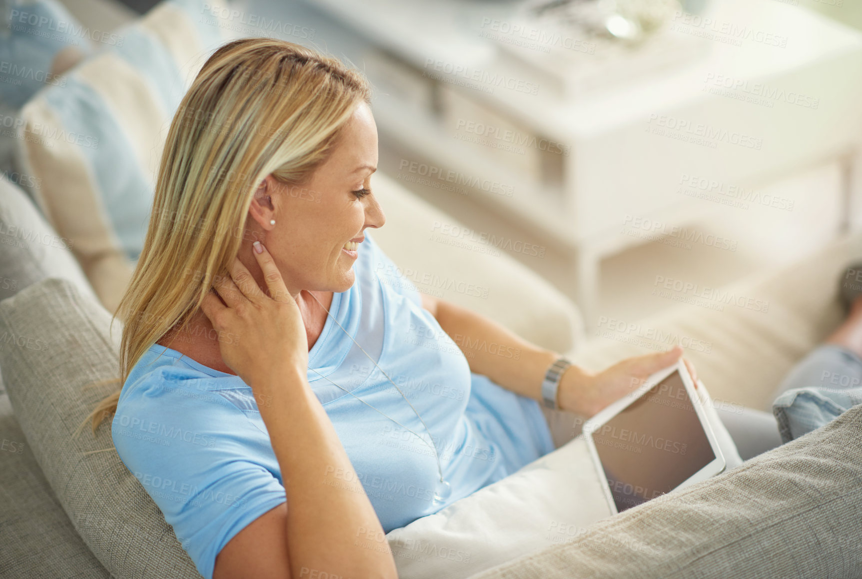 Buy stock photo Woman, tablet and relax on sofa in home with mock up space on screen with app, streaming or ebook in lounge. Mature person, digital touchscreen and reading with smile for movie, film or subscription