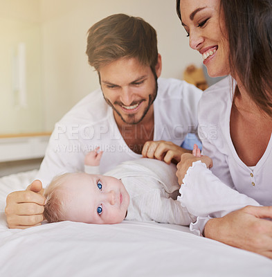 Buy stock photo Happy family, baby and parents on bed for love, care and quality time together in house. Mom, dad and cute newborn kid relax in bedroom of home for childhood development, caring support and happiness