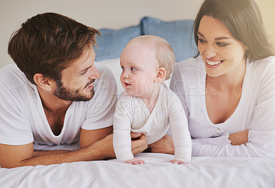 Buy stock photo Happy family, mother and father with baby on bed for love, care and quality time together at home. Mom, dad and cute newborn child relaxing in bedroom for happiness, support and development of kids 