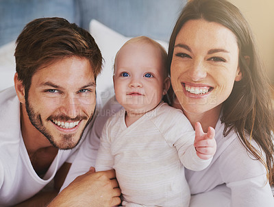 Buy stock photo Portrait of happy family, baby and parents with love, care and quality time together at home. Mom, dad and cute newborn kid relaxing with smile, happiness and support of healthy childhood development