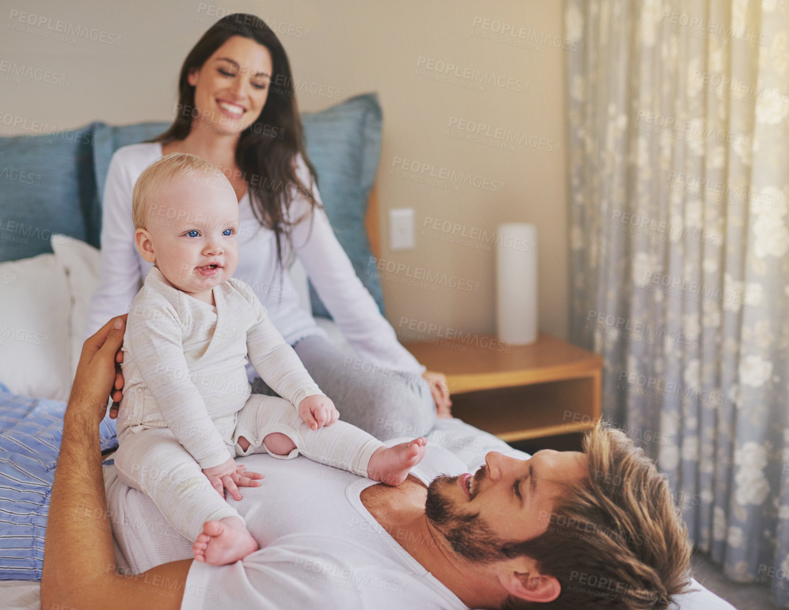 Buy stock photo Happy mother, father and fun with baby in bedroom for love, care and quality time to relax together at home. Mom, dad and parents playing with infant kid for happiness, support or newborn development