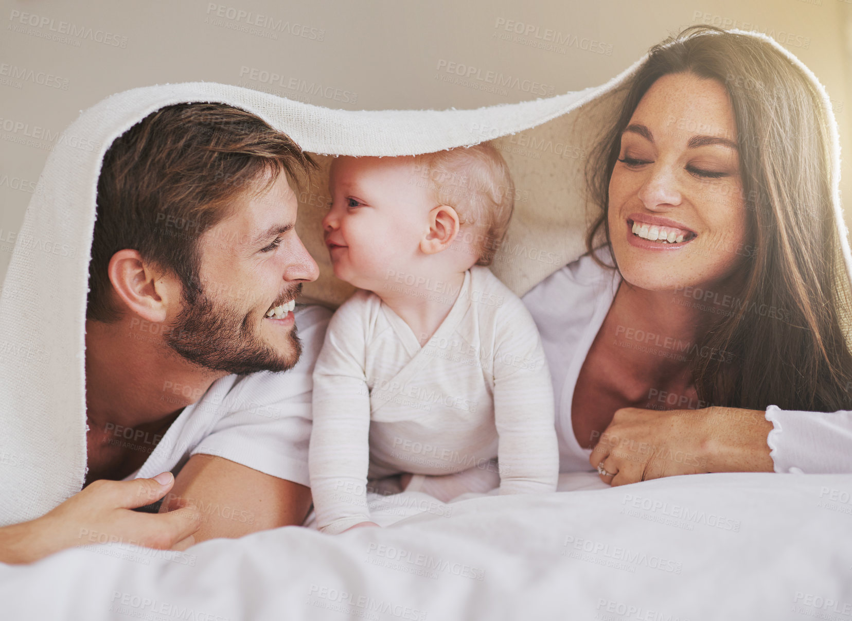 Buy stock photo Cropped shot of a young couple and their baby daughter in the bedroom