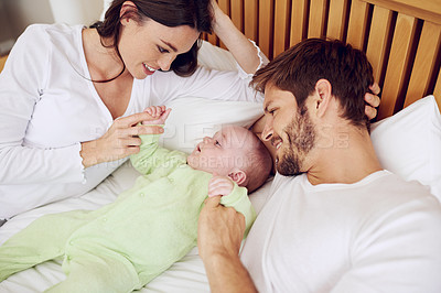 Buy stock photo Top view of mother, father and baby in bedroom for love, care and quality time together at home. Happy parents, family and newborn kid relax on bed with support, childhood development and nurture 