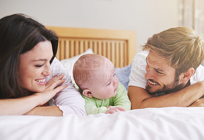 Buy stock photo Mother, father and baby relax on bed for love, care and fun quality time together at home. Happy family, parents and newborn bonding in bedroom for support, happiness or nurture childhood development
