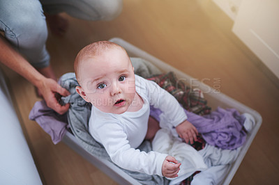 Buy stock photo Laundry, washing and portrait of baby in basket in home for multitasking, housekeeping and housework. Family, childhood and above of parent with newborn for cleaning, hygiene and maintenance on floor