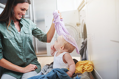 Buy stock photo Laundry, washing and mother with baby in clothes for multitasking, housekeeping and housework. Family home, parenting and mom with newborn in basket for cleaning, playing and maintenance on floor