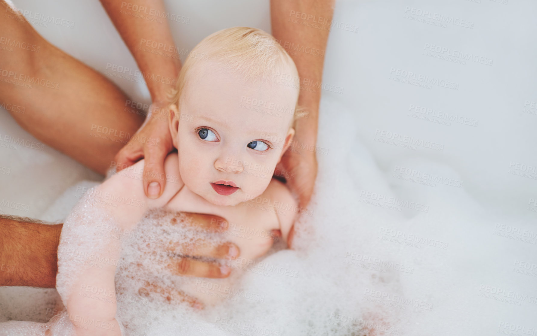 Buy stock photo Soap, bubbles and baby in bath for cleaning, washing and hygiene with hands of parents in home. Family, bathroom and newborn infant in bathtub, foam and water for wellness, health and childcare