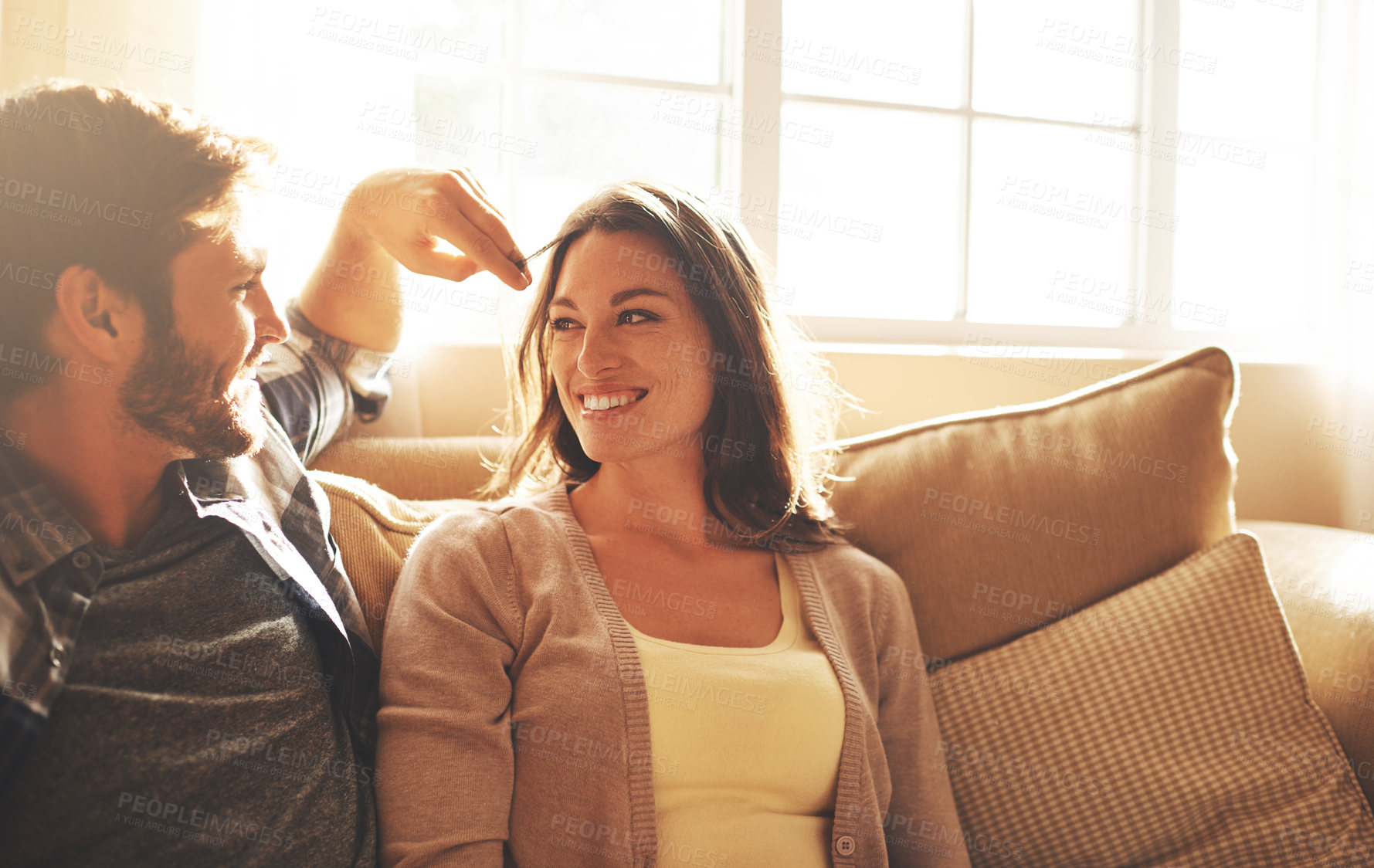 Buy stock photo Love, happy and couple talking on sofa for bonding, loving relationship and relax together in home. Marriage, morning and man and woman on couch for conversation, chatting and laugh in living room