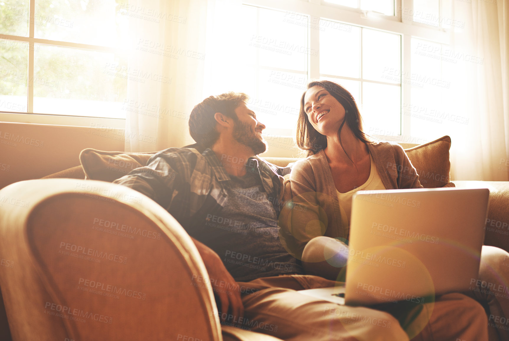 Buy stock photo Cropped shot of a young couple relaxing on the sofa at home