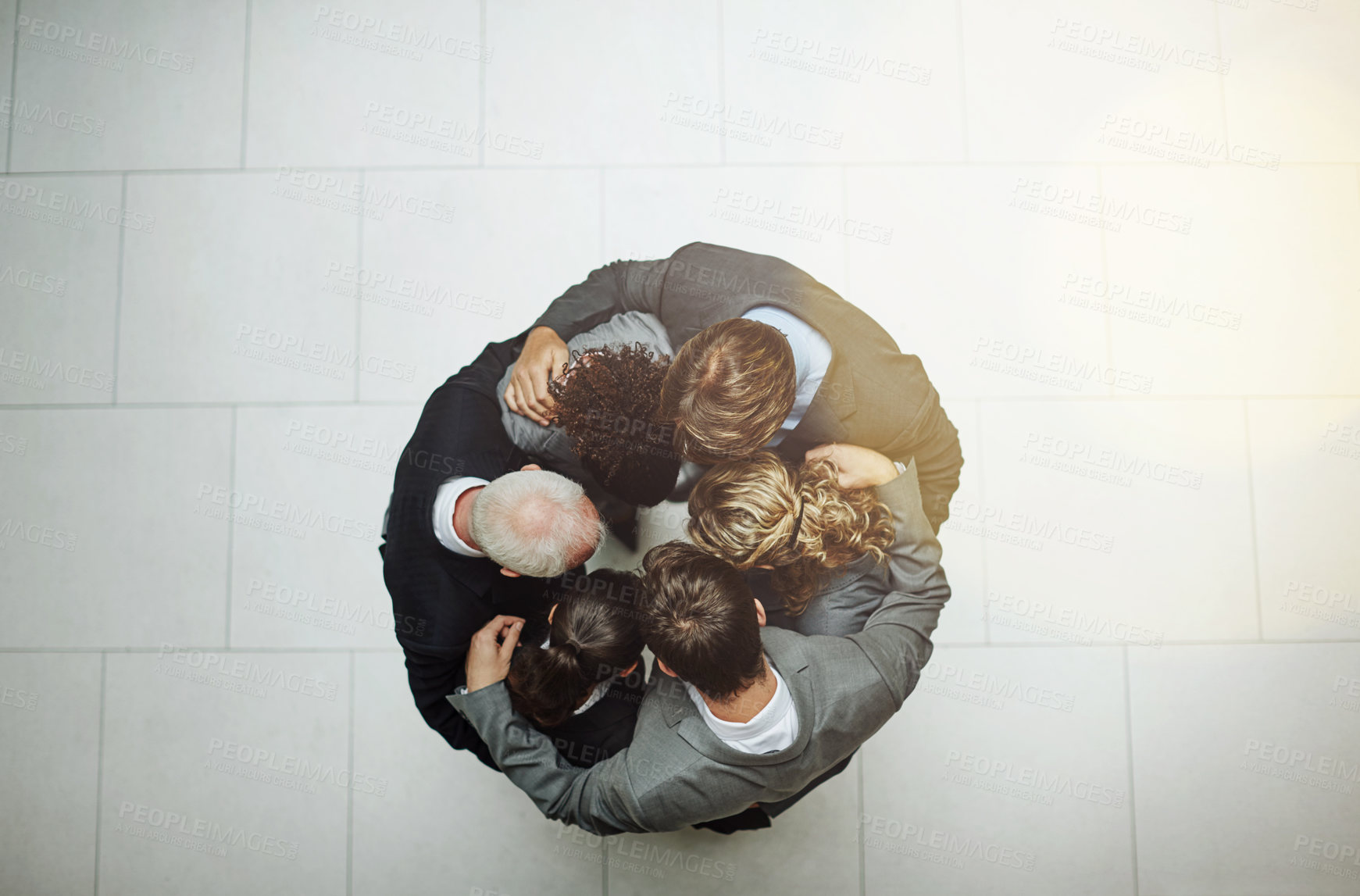 Buy stock photo High angle shot of a group of businesspeople standing in a huddle