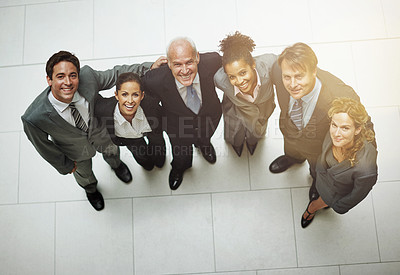 Buy stock photo High angle portrait of a group of businesspeople standing shoulder to shoulder in the office lobby