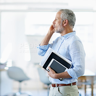 Buy stock photo Cropped shot of a mature businessman talking on his cellphone