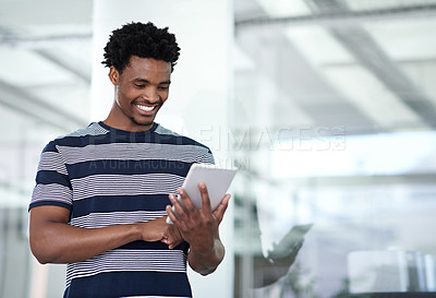 Buy stock photo Cropped shot of a young businessman using his tablet in the office