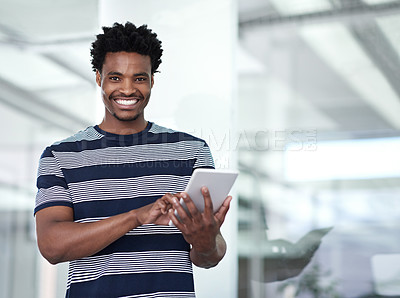 Buy stock photo Cropped portrait of a young businessman using his tablet in the office