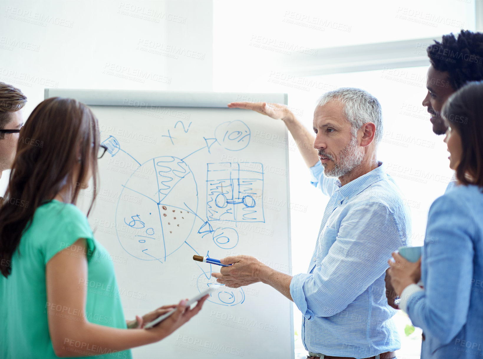 Buy stock photo Cropped shot of a mature businessman meeting with his creative team