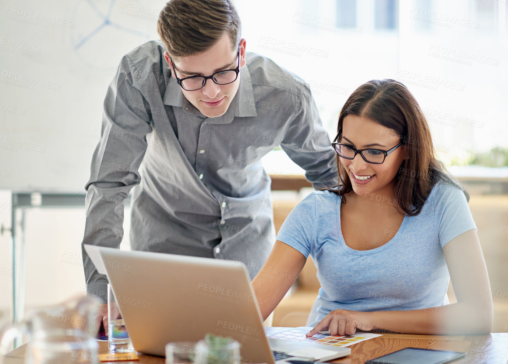 Buy stock photo Shot of two designers working together at a laptop in an office