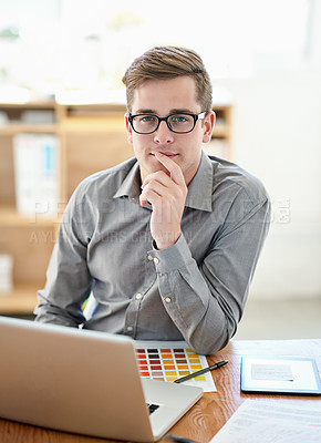 Buy stock photo Portrait of a male designer working on a laptop in an office