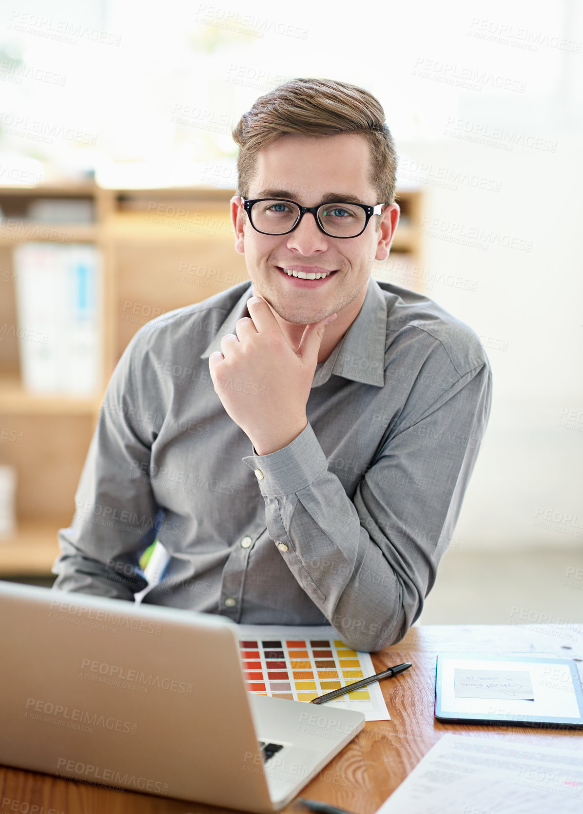 Buy stock photo Portrait of a male designer working on a laptop in an office