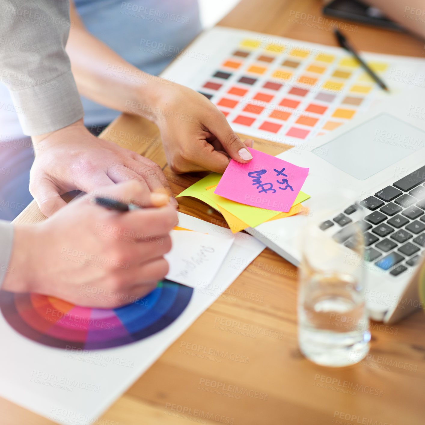 Buy stock photo Shot of two unrecognizable designers working with color swatches in their office