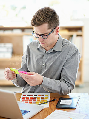 Buy stock photo Shot of a male designer working on a creative project at his desk
