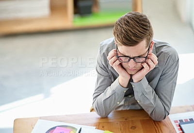 Buy stock photo Shot of a male designer struggling to come up with ideas