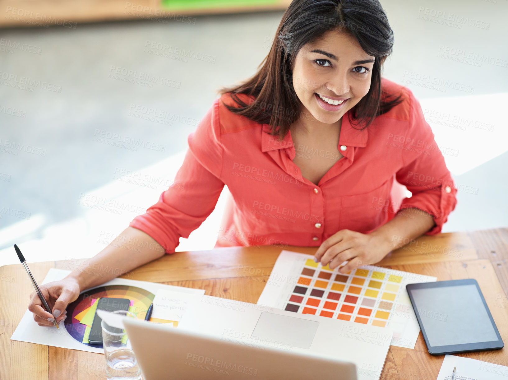 Buy stock photo Cropped portrait of a female designer working on a creative project at her desk