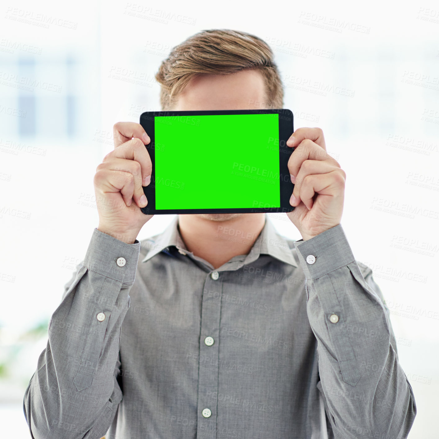 Buy stock photo Shot of a man holding a digital tablet with a chroma key screen in front of his face
