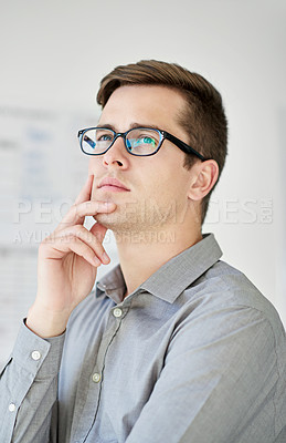 Buy stock photo Cropped shot of a young businessman with a pensive look