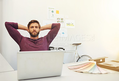 Buy stock photo Cropped shot of a young architect sitting with his hands behind his head