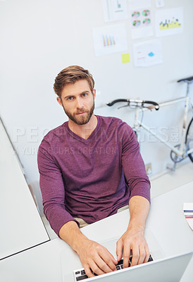 Buy stock photo Cropped portrait of a young architect working on his latop