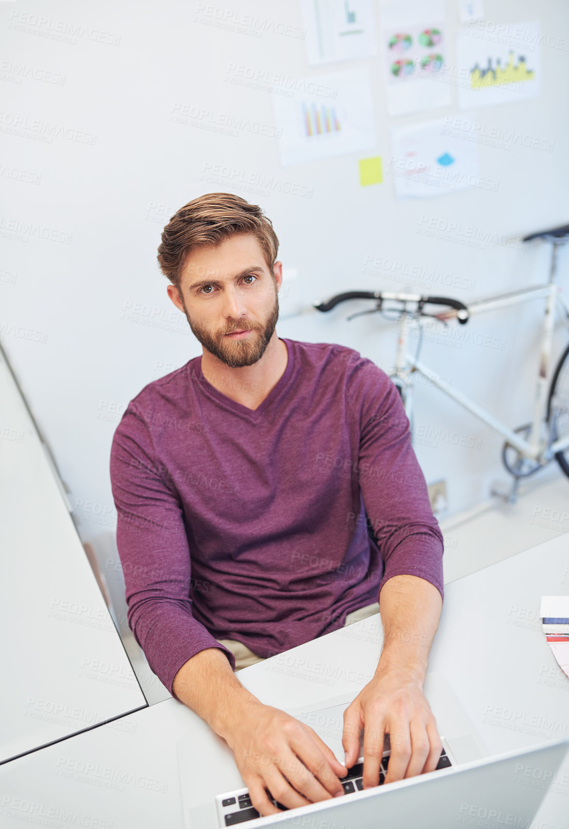 Buy stock photo Cropped portrait of a young architect working on his latop