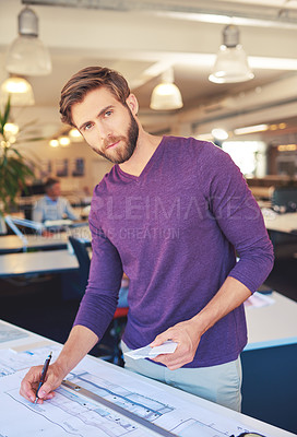 Buy stock photo Cropped shot of a young architect working on his drafting table