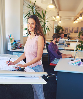 Buy stock photo Cropped portrait of a young architect working on her drafting table