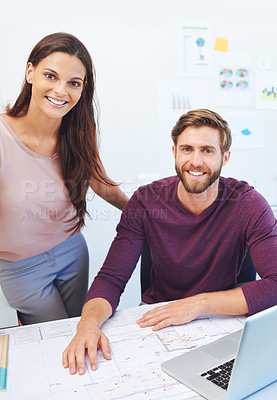 Buy stock photo Cropped portrait of two young architects looking over some building plans