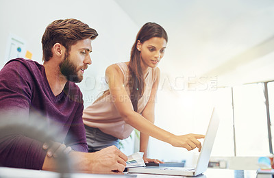 Buy stock photo Cropped shot of two young architects working on a laptop