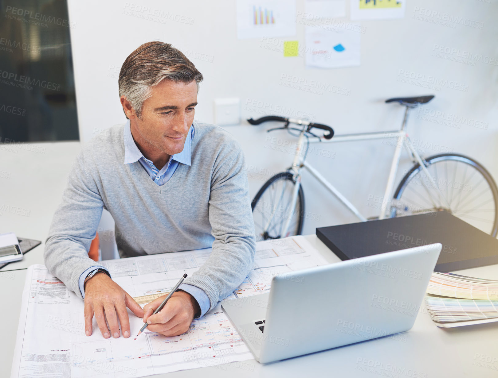Buy stock photo Cropped shot of a mature architect working on his laptop
