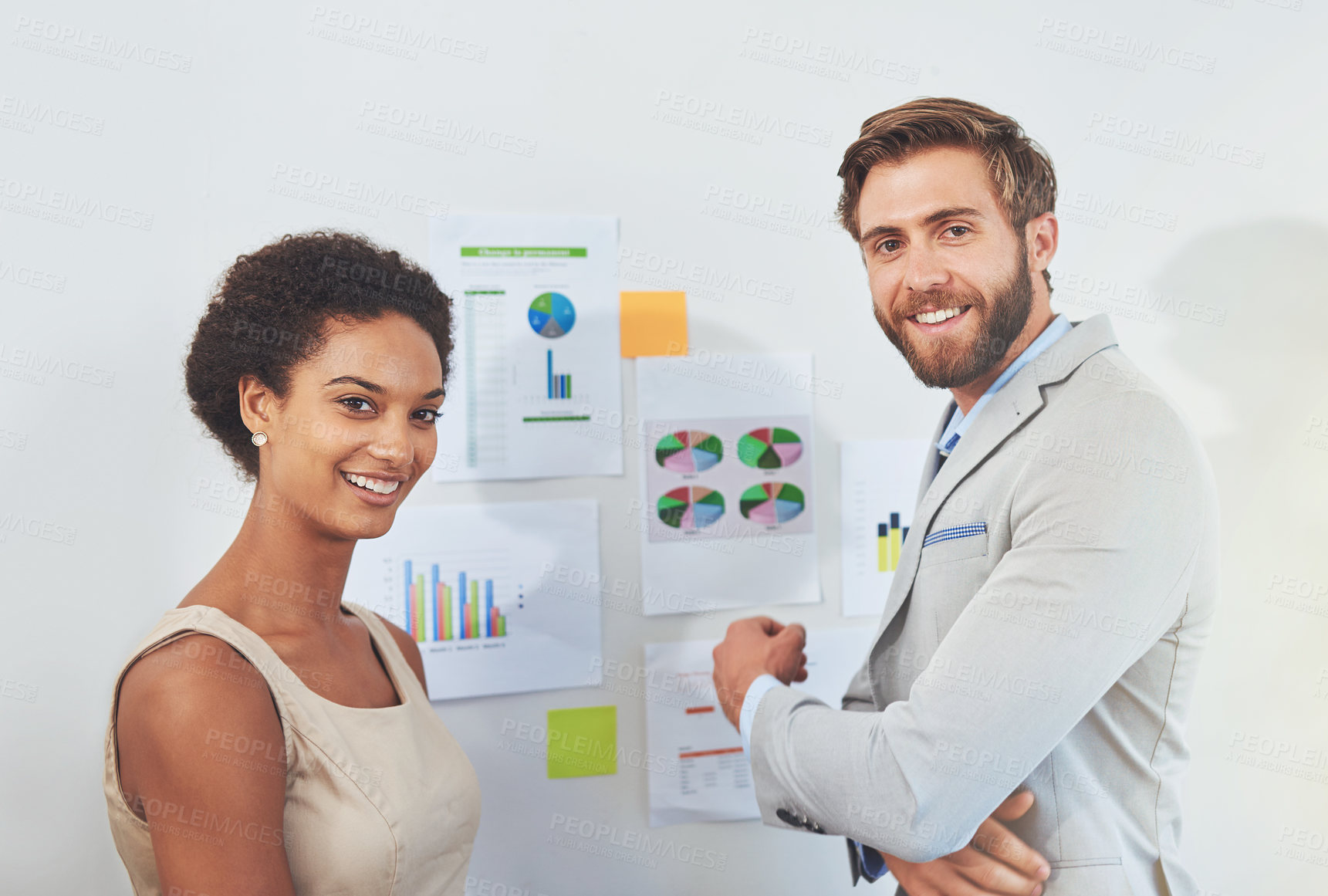 Buy stock photo Cropped portrait of two designers looking at plans on a wall