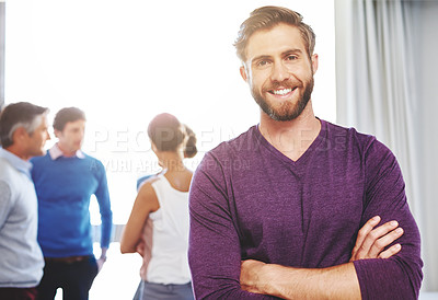 Buy stock photo Portrait of a young businessman with his colleagues standing in the background