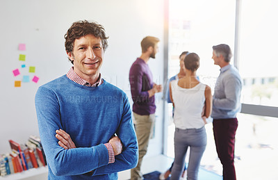 Buy stock photo Portrait of a businessman with his colleagues standing in the background