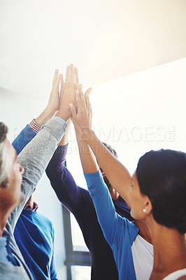 Buy stock photo Shot of a group of businesspeople giving each other a high five
