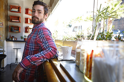 Buy stock photo Shot of a young man in a cafe