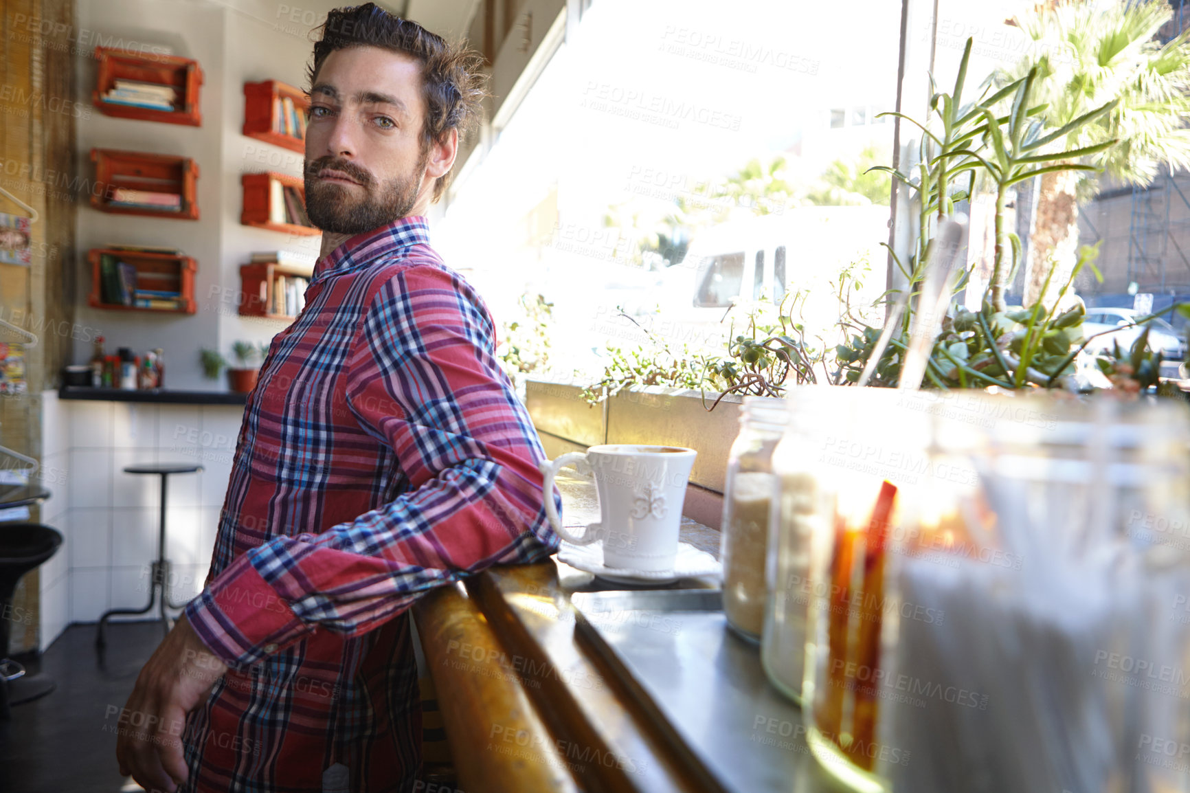 Buy stock photo Shot of a young man in a cafe